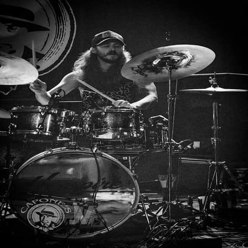 Jon Andre behind the kit, sticks in hand