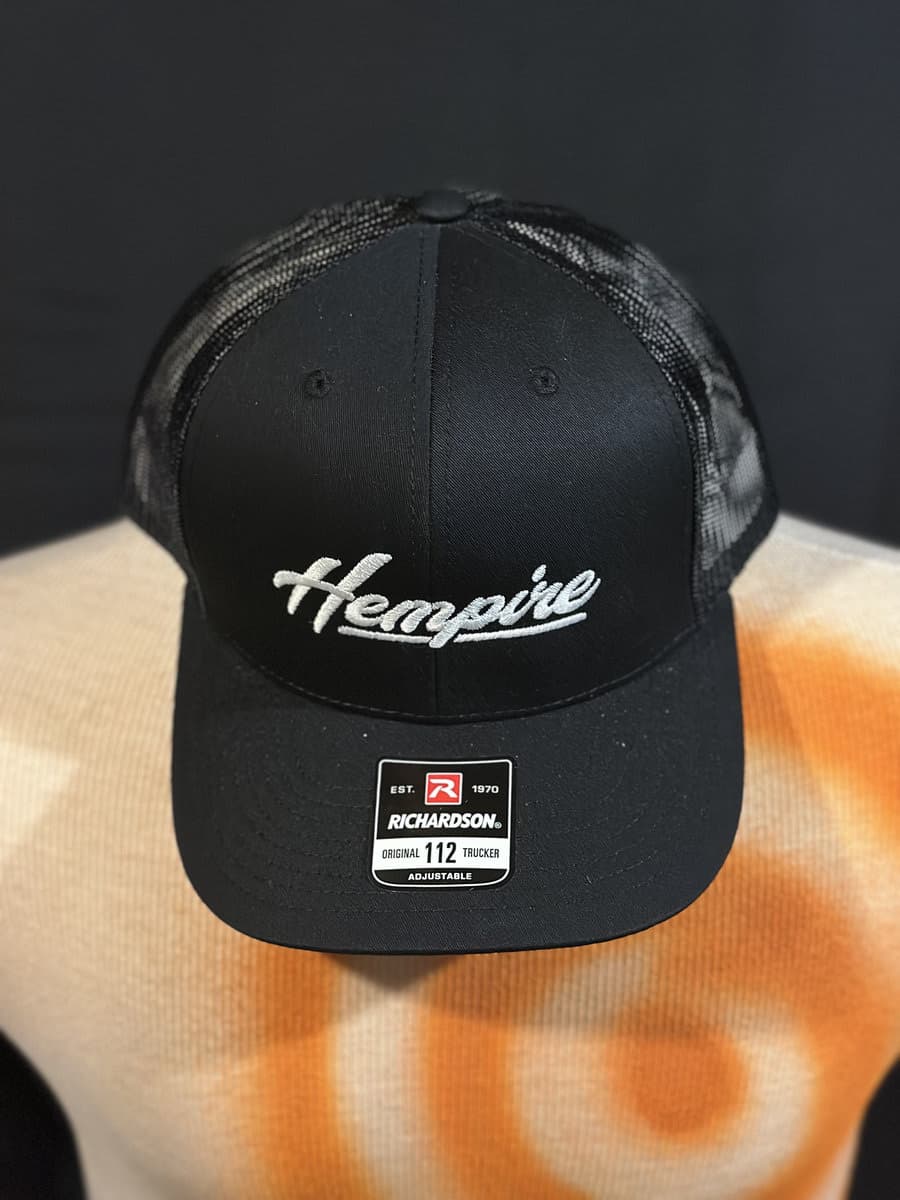 Black trucker hat with the embroidered Hempire script logo